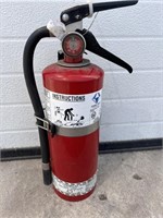 Red fire extinguisher with hose