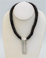 BLACK DISC AND SILVER NECKLACE