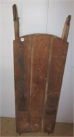 Primitive wood snow sled. Metal cover on runners.