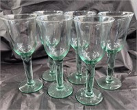 Set of six green hued wine glasses