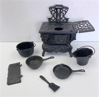 Miniature "Crescent" cast iron stove set with asso
