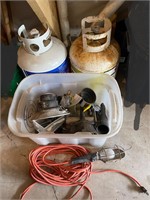 Two propane tanks and accessories in tote