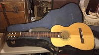 Andre acoustic guitar in the case needs strings