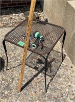 Metal patio table, sprinklers, and garden hose