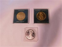 2 solid bronze souvenir coins in case: Washington