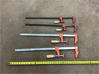 Four mid size adjustable clamps