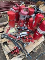 Skid of extinguishers, brackets and hoses