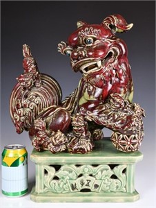 A Carved Porcelain Lion Statue with Stand