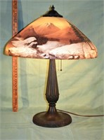 Cast metal table lamp with reverse painted shade