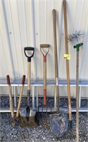 Large lot of tools including shovels, rakes, and