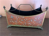 Ornate metal magazine holder with brass accents
