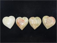 4 carved stone hearts.
