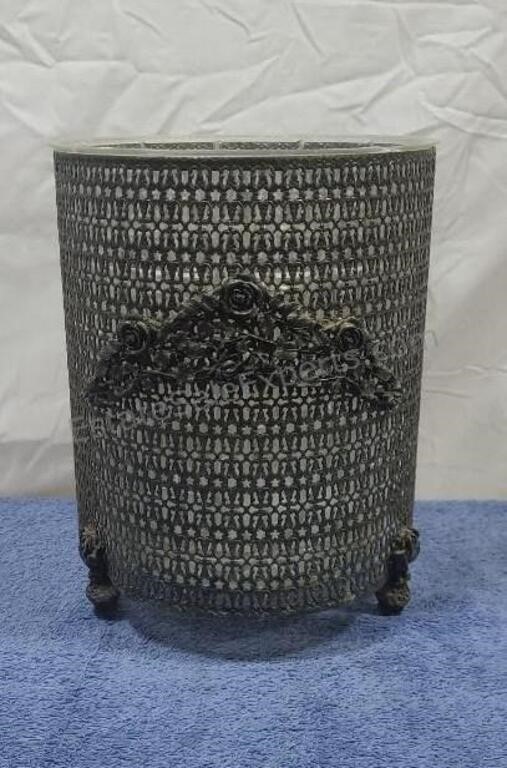 Steel mesh waste basket with plastic insert.