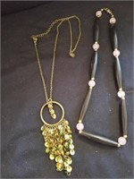 Two women's necklaces one has sequins