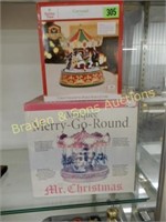 GROUP OF 2 CHRISTMAS CAROUSELS WITH BOXES