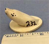 1 1/4" tall by 2' carving of a seal head "breaking