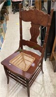 Beautiful antique carved back chair with wicker