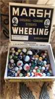 Cigar box of marbles with shooters