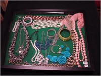 Container of costume jewelry, mostly beaded