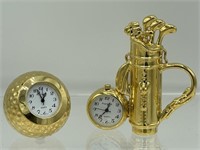 2  Miniature brass clocks, a golf ball and golf