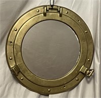 Vintage brass porthole mirror.