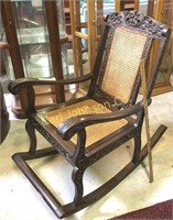 ANTIQUE CARVED WOOD ROCKER W/ RUSH SEAT & BACK