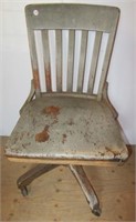 Wooden swivel chair with brass tag "Defense Plant