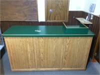 Oak cashier counter with green laminate top