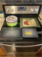 3 cutting boards and one cookie tin