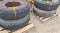 Four 11.00-20 tires on open center rims