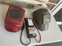 2 welding helmets and battery tester