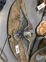 Metal eagle mounted on wood, 22" wide