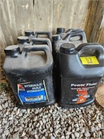 (6) jugs of hydraulic fluid. All full