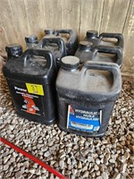 (6) jugs of Hydraulic fluid. 1 is partial used.