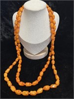 Long burnt orange glass bead necklace; vintage
