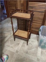 Two tier shelf, wood and rattan . 16.25" W 30" T