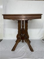 ORNATE WOODEN TABLE WITH WHEELS