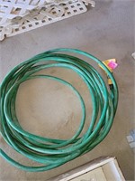 Garden hose with sprayer at end