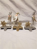 3 silver and gold stocking hangers