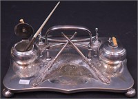 A silverplate figural double inkwell in the form
