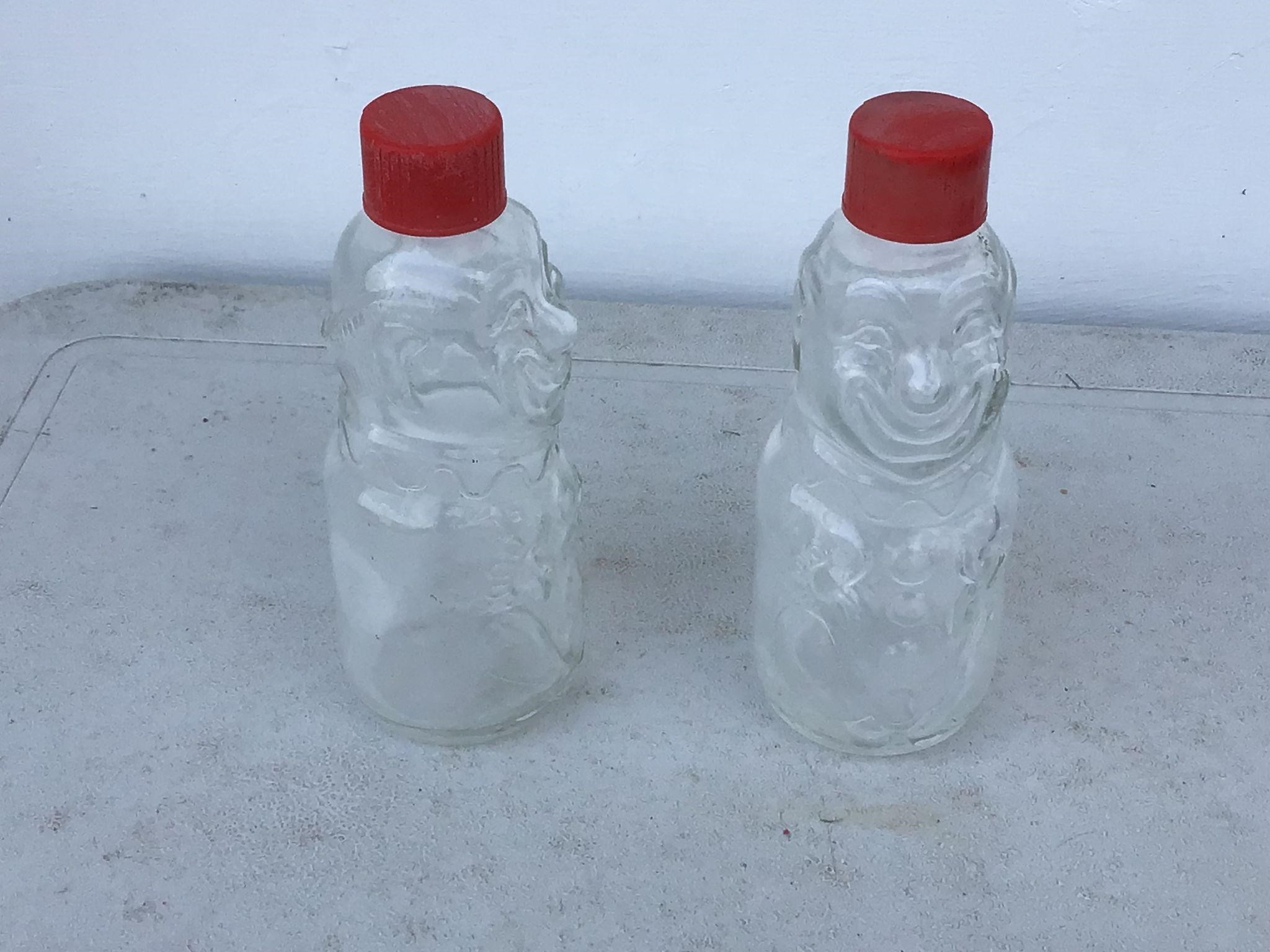 2 SMALL GLASS BOTTLES WITH FACES