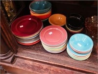 47 multicolored ceramic plates and bowls in