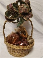 Glass acorns in a gold basket with burlap