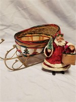 Wicker and gold sleigh and small Santa with gift