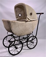 Wicker baby carriage, folding hood has portholes,