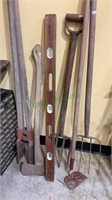 Garden tools and a brass and wooden level - six