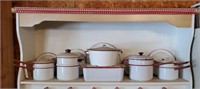 Red enamelware cookware,  pots, pans, lids