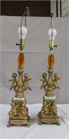 Pair of metal and marble base cherub lamps