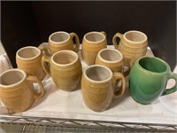 Nine pottery mugs