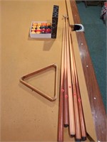 5 pool cues, rack, and balls